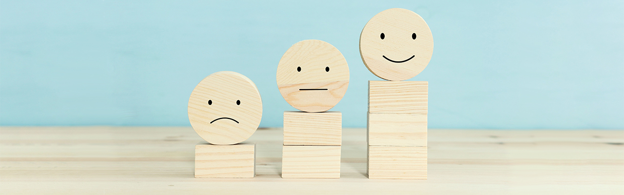 blocks with sad, neutral, and happy faces