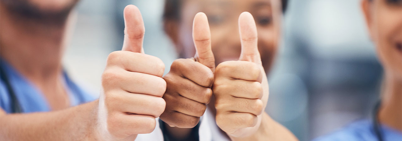 dental office staff giving thumbs up