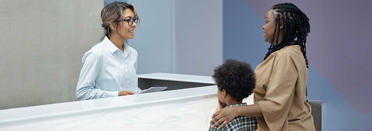 dental office manager talks to patients