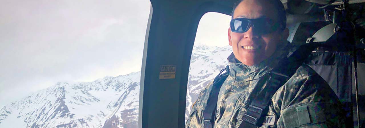 woman in helicopter with mountains in background