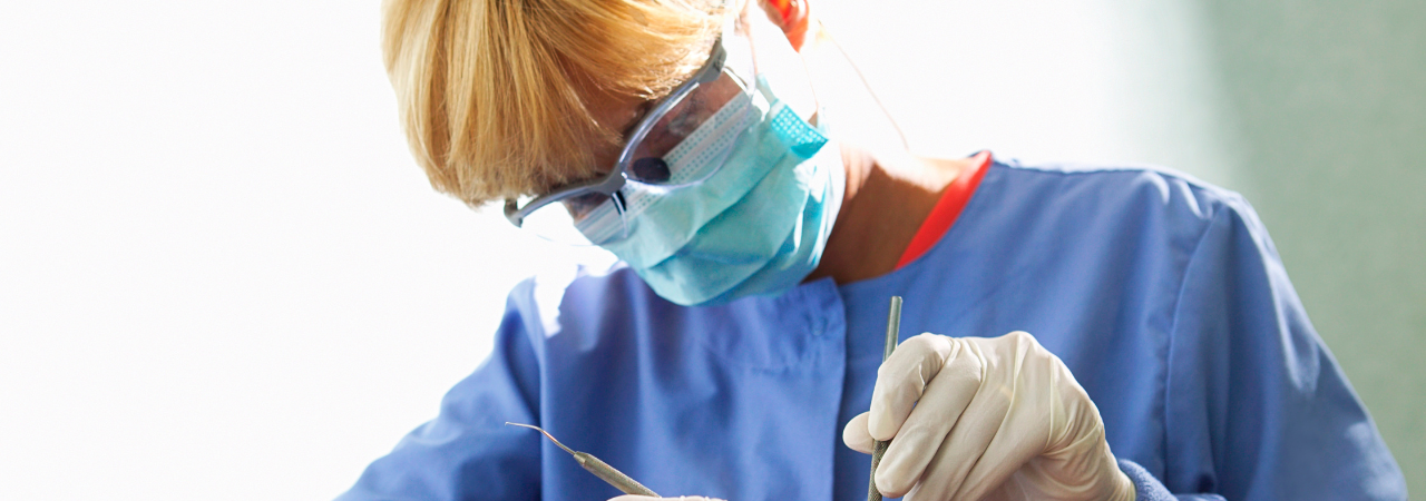 dental hygienist cleaning a patient's teeth